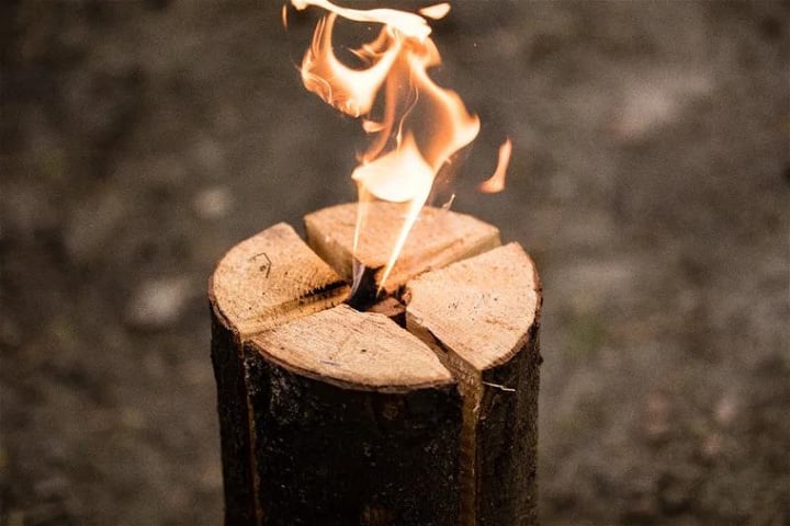 a log cut in quarted with flames