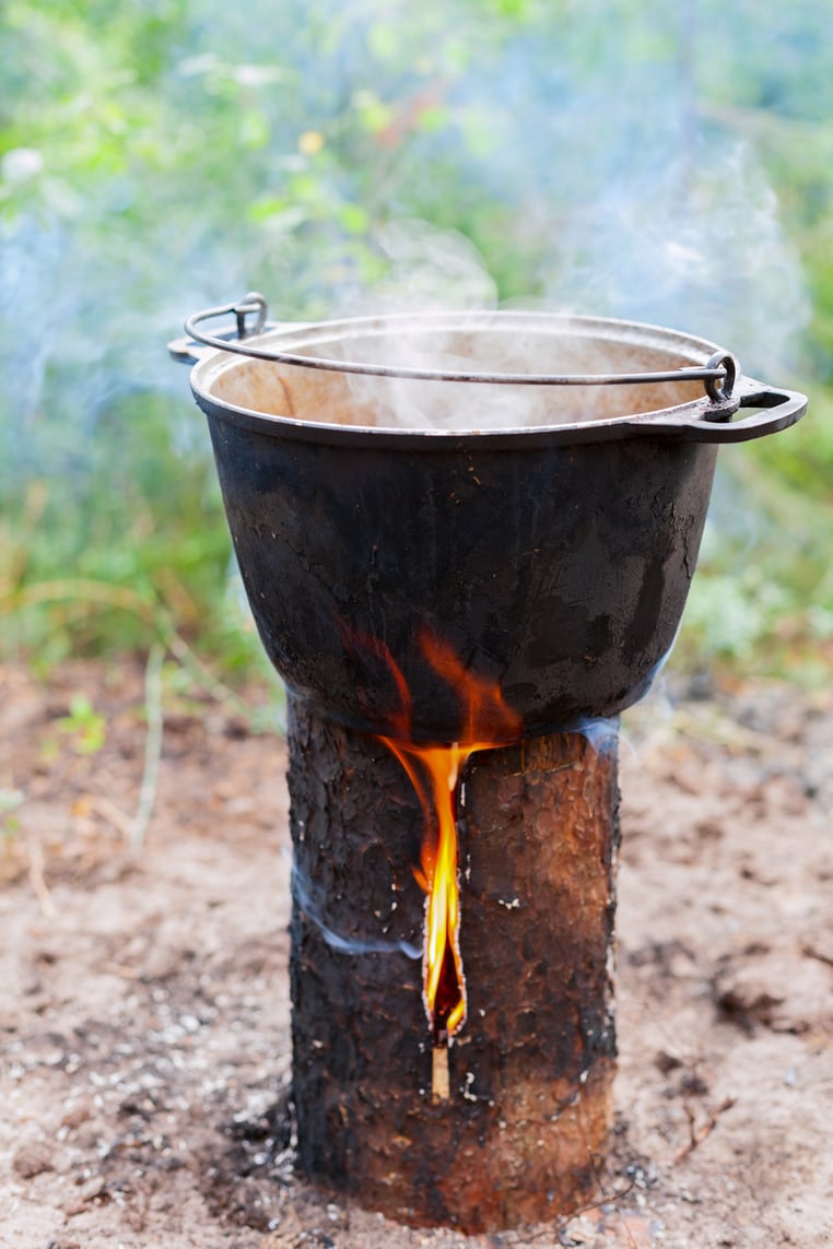 a pot cooking on a swedish candle